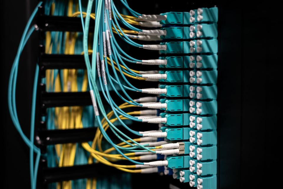 Network rack with neatly dressed patch cables and fiber jumpers